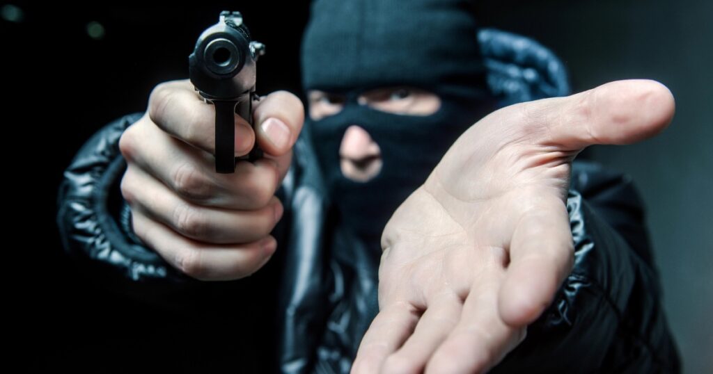 photo of a masked robber with a pistol